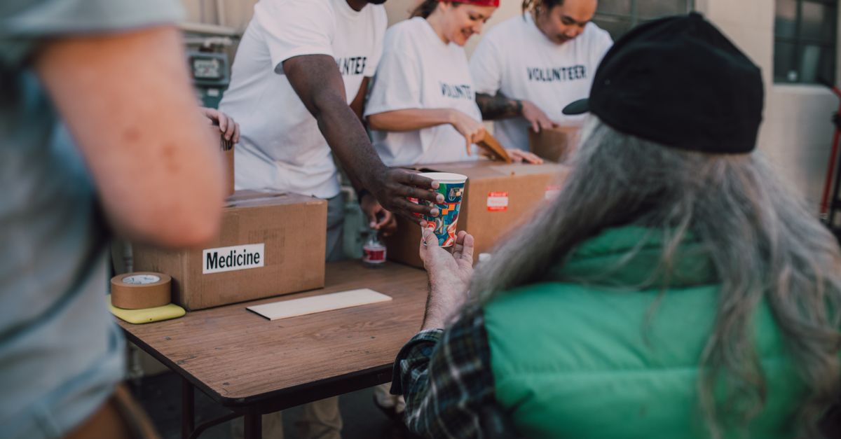 Volunteers handing out donations and support to those in need at a community event.